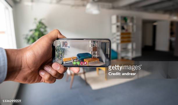real estate agent making an online viewing of a house using his cell phone - virtual visit stock pictures, royalty-free photos & images