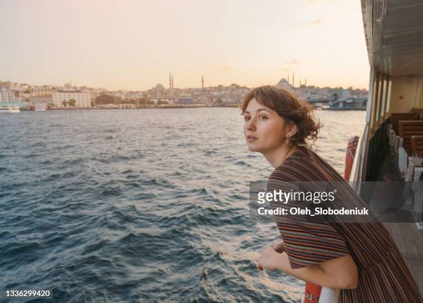 woman traveling on ferry through bosphorus in istanbul - istanbul stock pictures, royalty-free photos & images