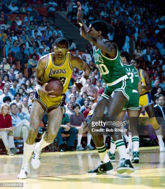 Los Angeles Lakers Kareem Abdul-Jabbar drives towards basket as Boston Celtics Robert Parish defends during 1985 NBA Finals between Los Angeles...