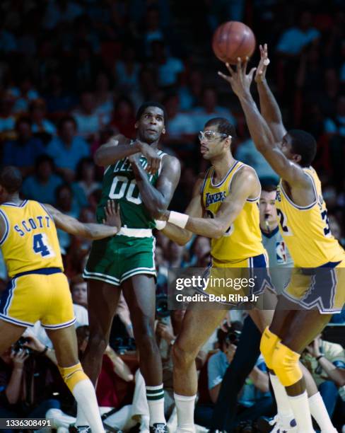 Los Angeles Lakers Magic Johnson and Kareem Abdul-Jabbar defend against Boston Celtics Robert Parish during 1985 NBA Finals between Los Angeles...