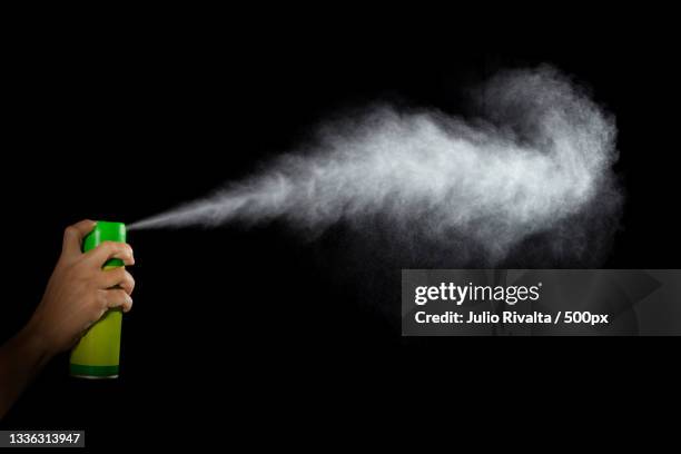 cropped hand holding bottle against black background,santa clara,cuba - exploding ice stock pictures, royalty-free photos & images