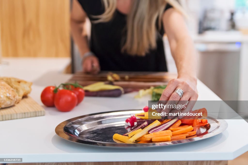 Close-up on woman's hands preparing lunch in home kitchen.