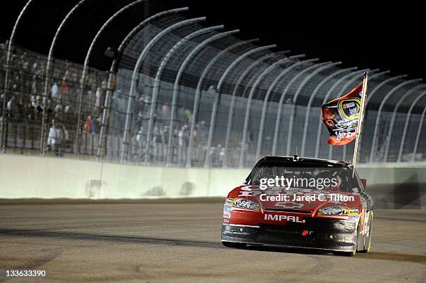 Tony Stewart, driver of the Office Depot/Mobil 1 Chevrolet, celebrates after winning the NASCAR Sprint Cup Series Ford 400 and the 2011 Series...
