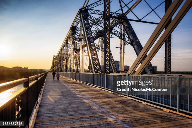 wide view of ottawa gatineau alexandra bridge at sunset - ottawa people stock pictures, royalty-free photos & images