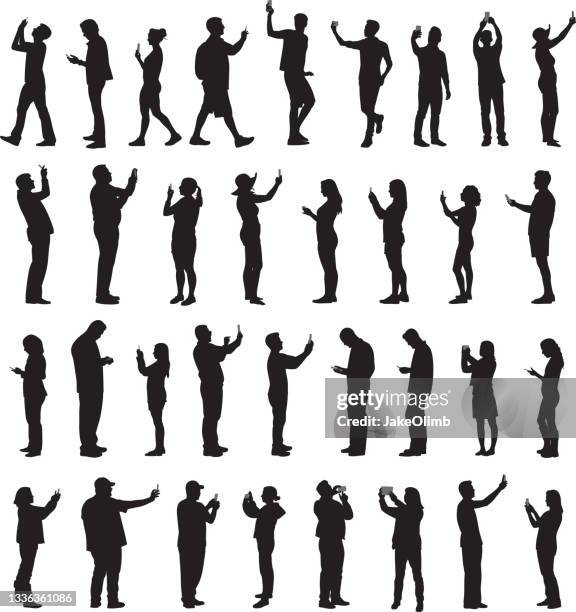 people holding smartphone up silhouettes - holding tablet computer stock illustrations
