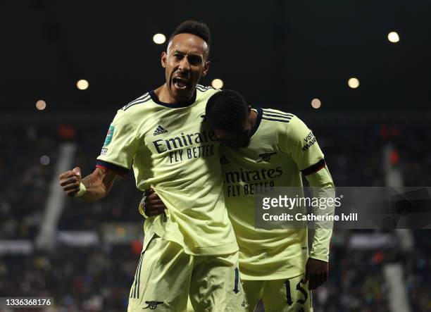 Pierre-Emerick Aubameyang of Arsenal celebrates with team mate Ainsley Maitland-Niles after scoring his sides fifth goal and his hat trick the...