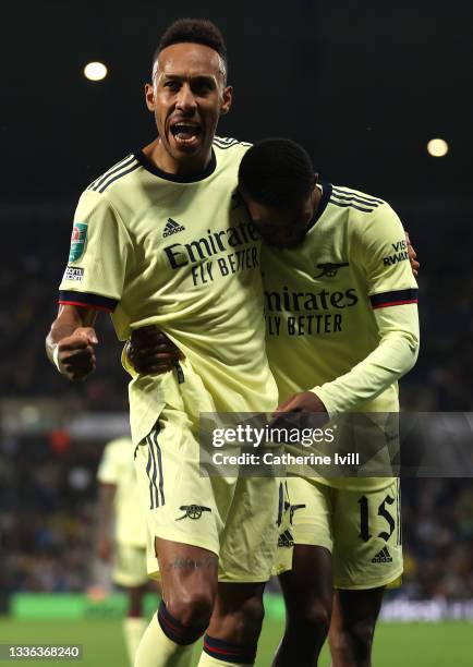 Pierre-Emerick Aubameyang of Arsenal celebrates with team mate Ainsley Maitland-Niles after scoring his sides fifth goal and his hat trick the...