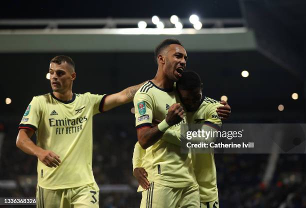 Pierre-Emerick Aubameyang of Arsenal celebrates with team mates Ainsley Maitland-Niles and Granit Xhaka after scoring his sides fifth goal and his...