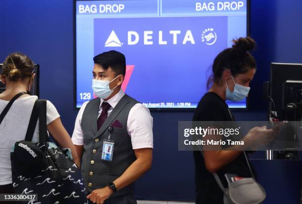 Delta Air Lines employee works on the departures level at Los Angeles International Airport on August 25, 2021 in Los Angeles, California. Delta is...