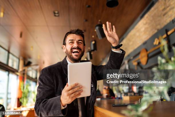 portrait of successful young businessman enjoying in cup of coffee with his digital tablet - restaurant manager covid stock pictures, royalty-free photos & images