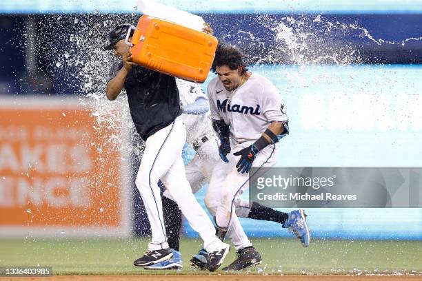 Jorge Alfaro of the Miami Marlins celebrates with teammates after hitting a walk-off RBI single during the tenth inning against the Washington...
