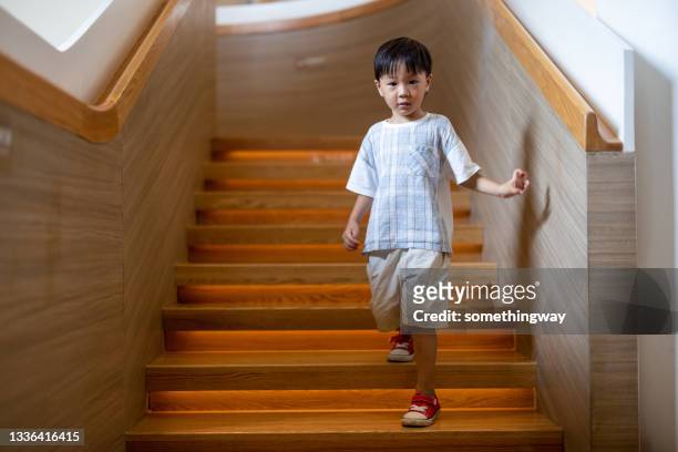 little boy down the stairs - kid looking down stock pictures, royalty-free photos & images