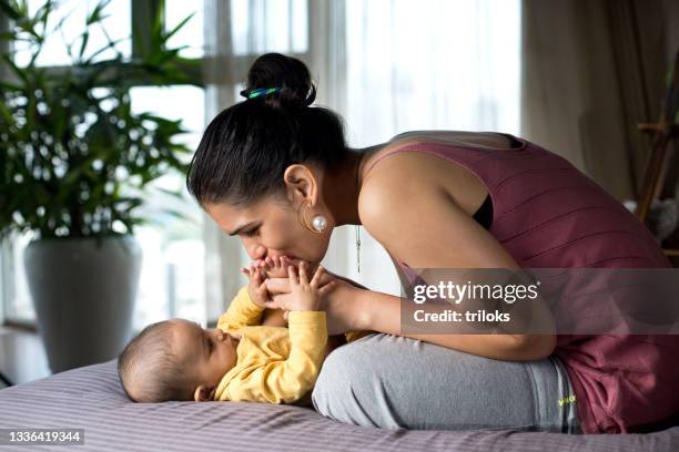 mother playing with her baby son at home - reclining stock pictures, royalty-free photos & images
