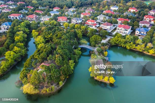 by the lake at the foot of the mountain, there are a large group of villas. jiangyin city, jiangsu province, china. - forest flowers water stock pictures, royalty-free photos & images