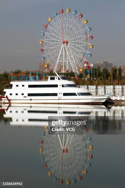 Ferris wheel, roller coaster and yacht are seen by Wulanmulun lake at Kangbashi District on October 16, 2013 in Ordos, Inner Mongolia Autonomous...