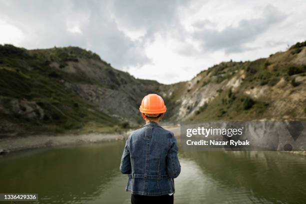 female engineer watching on the lake - safe environment stock pictures, royalty-free photos & images