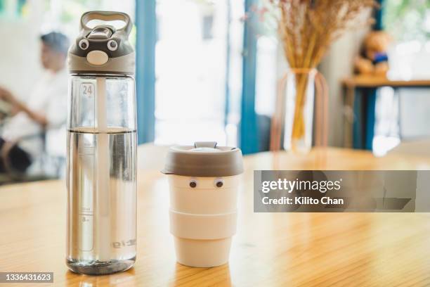 funny reusable water bottle and travel coffee mug with googly eyes - reusable stock pictures, royalty-free photos & images