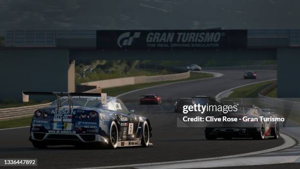 Race action from the Manufacturers Series competition during the Gran Turismo World Series Showdown run at the virtual Dragon Trail Gardens circuit...