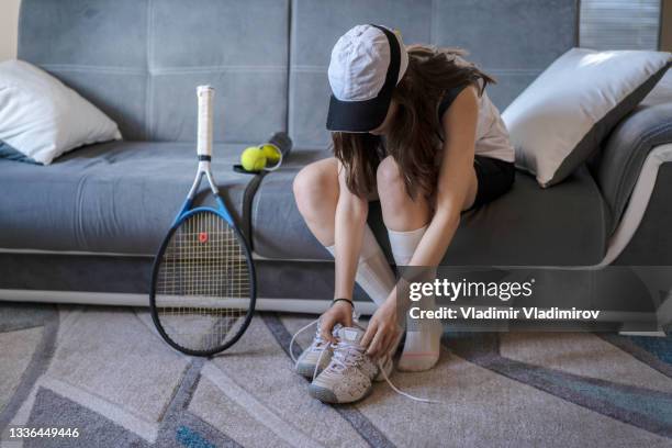 teenager bending over to put her trainers on - tennis racquet stock pictures, royalty-free photos & images