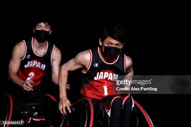 Arika Toyoshima and Renshi Chokai of Team Japan make their way onto the court during the Wheelchair Basketball Men's preliminary round group A match...