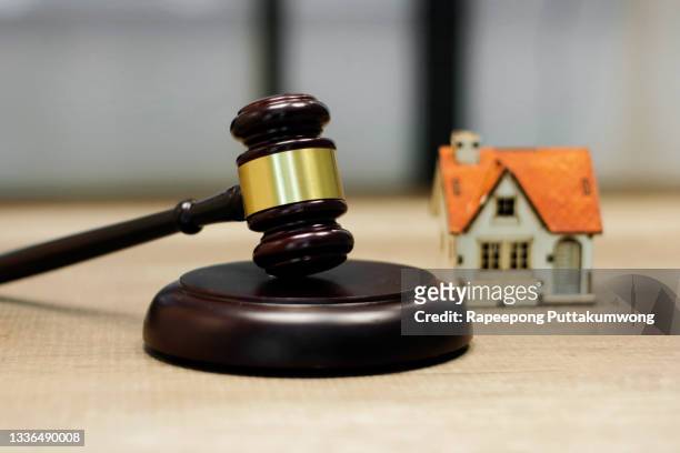 family law concept. house model and judge gavel on the table - judges table stock pictures, royalty-free photos & images