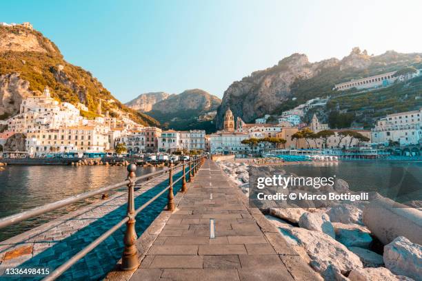 pier and cityscape in amalfi, campania, italy - アマルフィ海岸 ストックフォトと画像