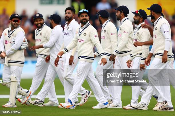 India captain Virat Kohli walks offfor the tea interval alongside his team after Mohammed Siraj captured the wicket of Dawid Malan during day two of...