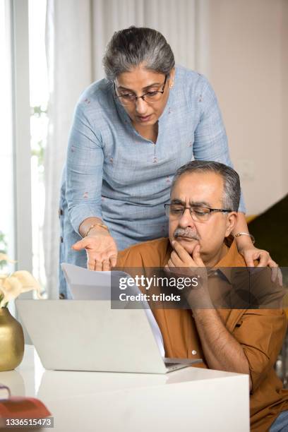 worried old couple reading a document at home - 401k stock pictures, royalty-free photos & images