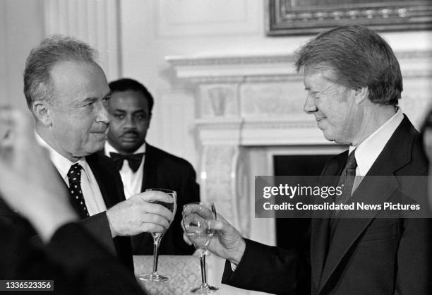 Israeli Prime Minister Yitzhak Rabin and US President Jimmy Carter exchange toasts at a working dinner in the White House's State Dining Room during...