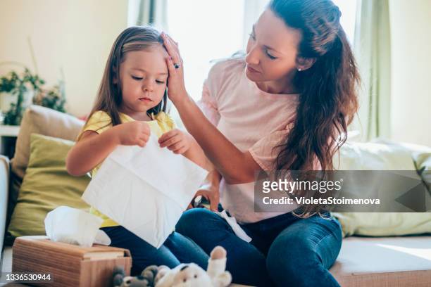mother taking care about her sick daughter. - paper napkin stock pictures, royalty-free photos & images