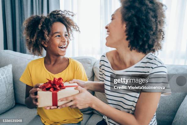 fröhliches kind, das ein geschenk von seiner mutter erhält. - child giving gift stock-fotos und bilder
