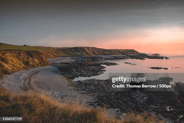 scenic view of sea against sky during sunset,nefyn,pwllheli,united kingdom,uk - wales beach stock pictures, royalty-free photos & images