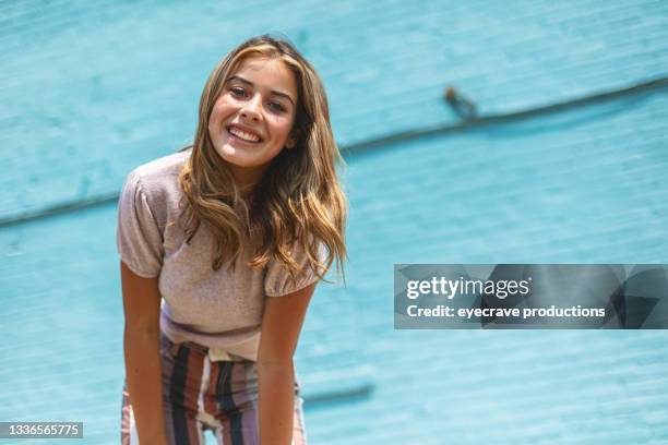 teenage female standing in front of blue brick wall urban photo series - 16 17 years stock pictures, royalty-free photos & images