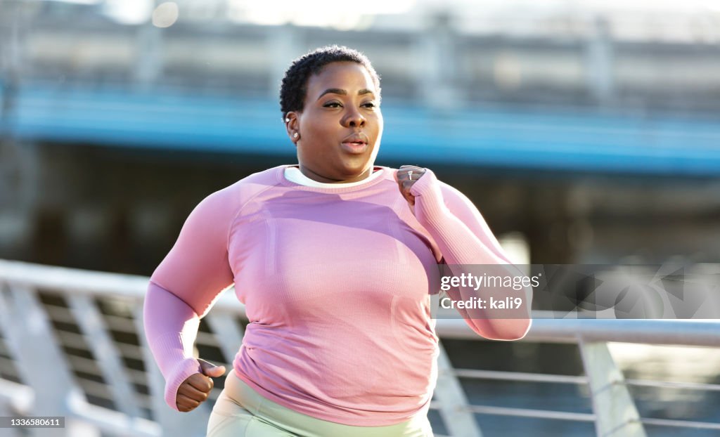 African-American woman with large build, running in city