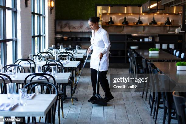 restaurant worker sweeping the floor - woman sweeping stock pictures, royalty-free photos & images