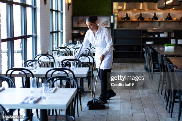 restaurant worker sweeping the floor - clean restaurant stock pictures, royalty-free photos & images