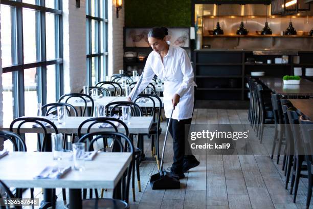 restaurant worker sweeping the floor - restaurant cleaning stock pictures, royalty-free photos & images