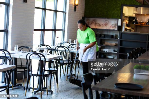 restaurant worker sweeping the floor - woman sweeping stock pictures, royalty-free photos & images