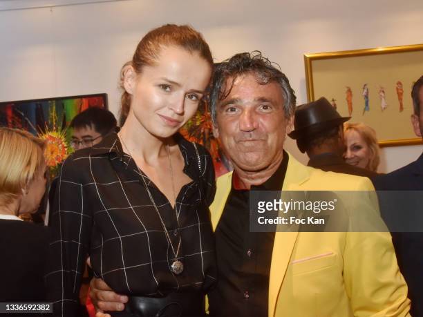 Model Elisabeth Oros and editor Luigi di Donna attend "Le Petit Echo De L'Art Et De La Mode" Auction Party At 12 ND Nazareth on August 26, 2021 in...