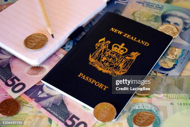 travel plan concept - new zealand passport with note pad and currency (nzd) - new zealand exchange stock pictures, royalty-free photos & images