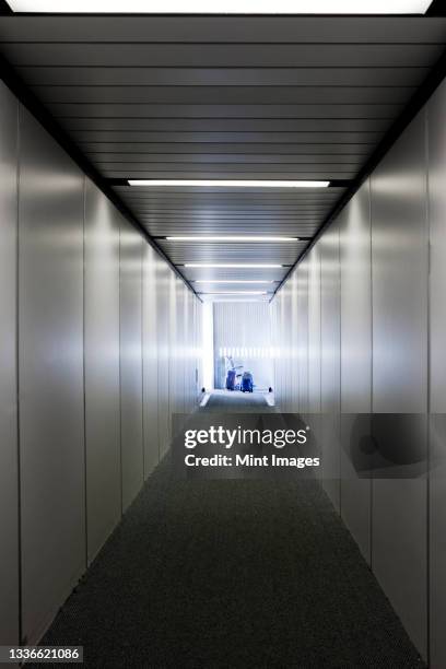 an empty narrow tunnel or corridor, a passenger airbridge. - passenger boarding bridge stock pictures, royalty-free photos & images