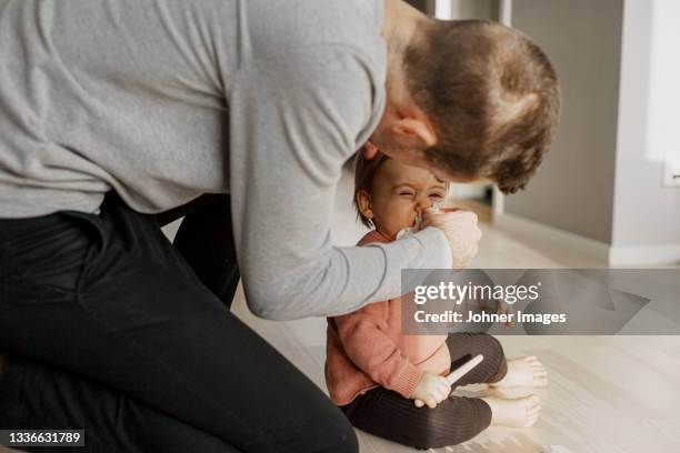 father wiping daughter's nose with tissue - blowing nose stock pictures, royalty-free photos & images