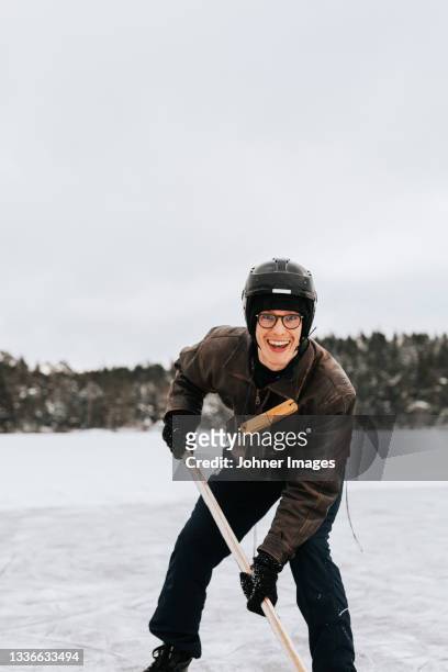 man ice-skating on frozen lake - hockey player stock-fotos und bilder