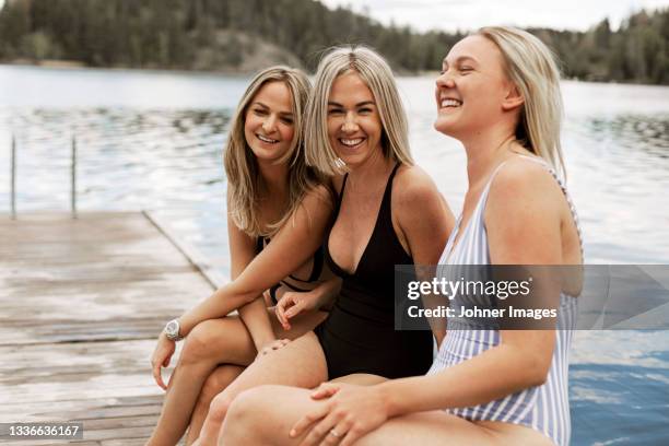 happy female friends at lake - bathing jetty stock pictures, royalty-free photos & images