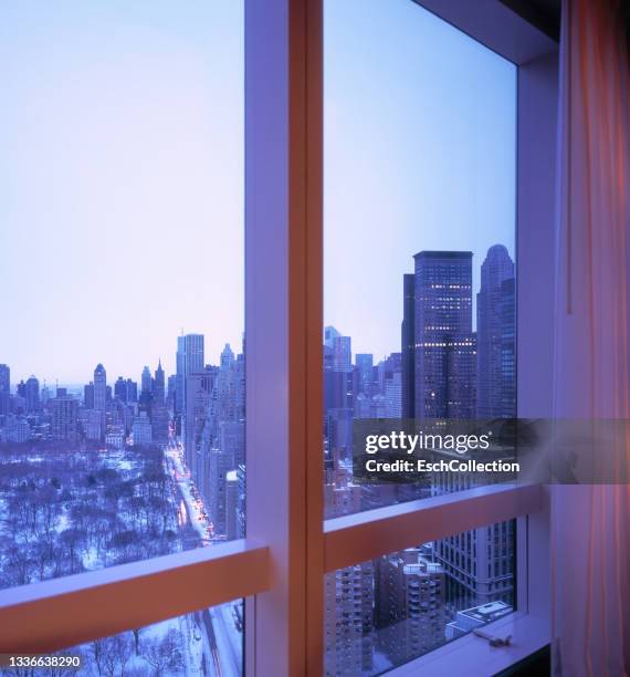 window with view of a snow covered central park, new york. - central park view stockfoto's en -beelden