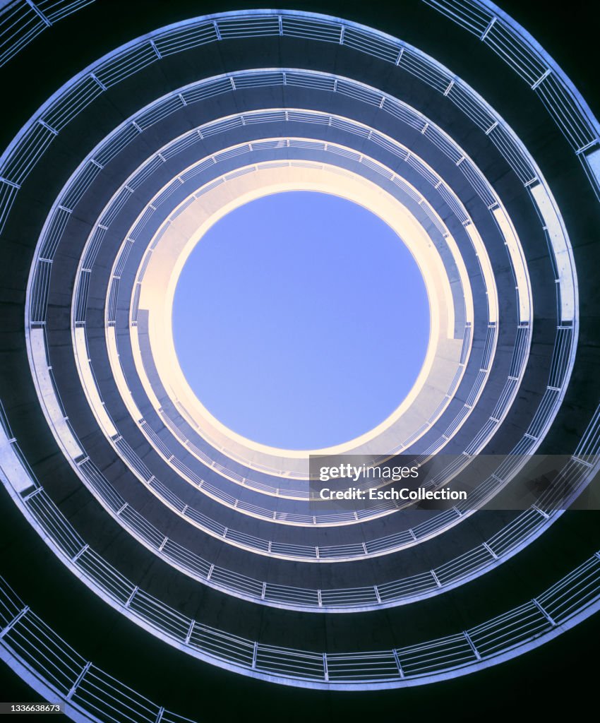 Morning sunlight entering spiral roadway of a parking garage