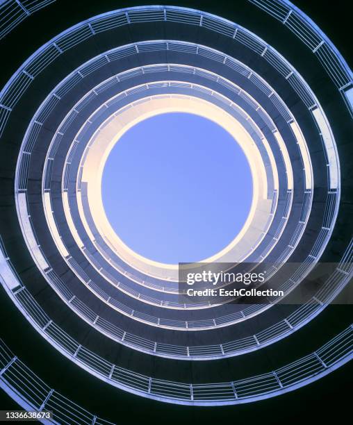 morning sunlight entering spiral roadway of a parking garage - abstract building bildbanksfoton och bilder