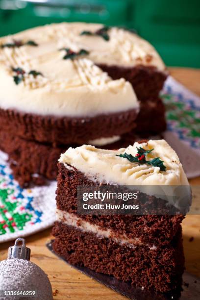 traditional sponge cake with christmas decoration in a home kitchen setting - christmas cake stock pictures, royalty-free photos & images