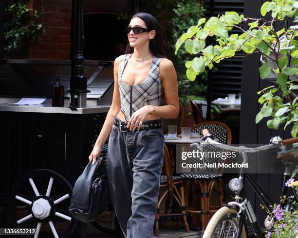 Dua Lipa seen leaving her hotel and heading to a studio on August 27, 2021 in London, England.