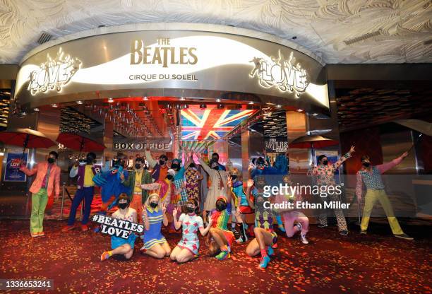 Cast members pose during a pop-up performance before the grand reopening of "The Beatles LOVE By Cirque du Soleil" at The Mirage Hotel & Casino on...
